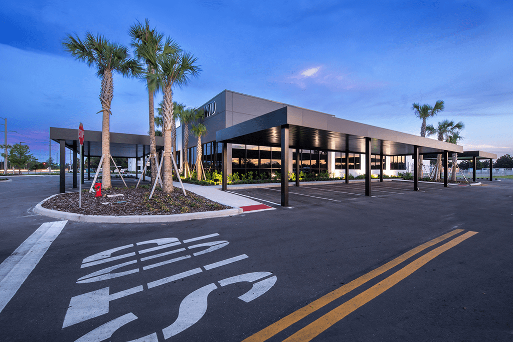Entrance to a parking lot surrounded by palm trees