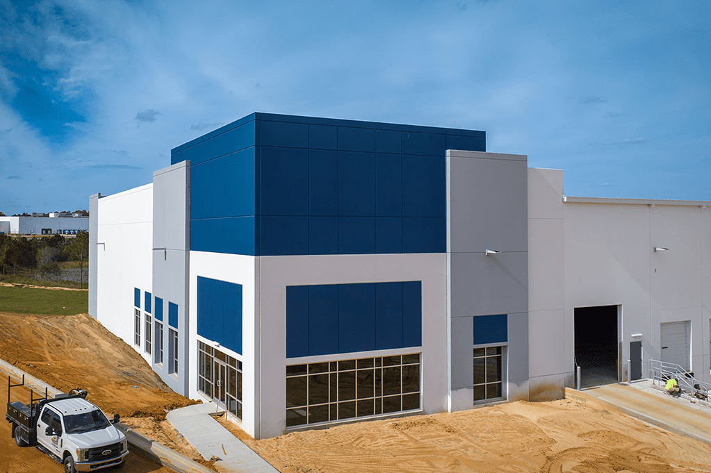 A large warehouse building featuring blue and white walls